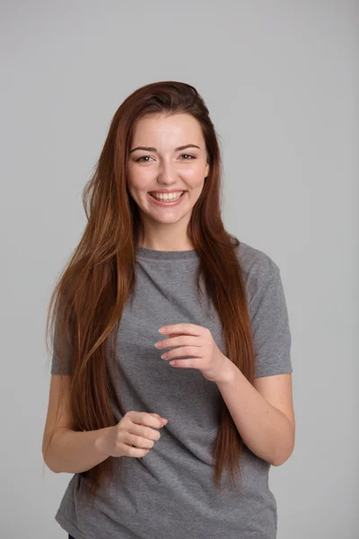 Attractive cheerful woman with beautiful long hair standing and laughing — Stock Photo, Image