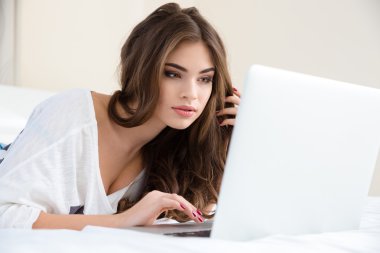 Portrait of attractive woman using laptop at home