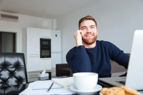 Usmívající se muž mluví po telefonu doma — Stock fotografie