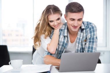 Dizüstü bilgisayar kullanan ve internet sörf mutlu çift 