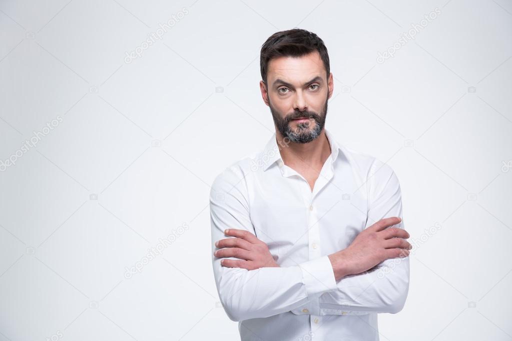 Businessman with arms folded looking at camera