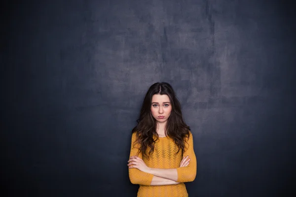 Sad woman standing with arms folded — Stock Photo, Image