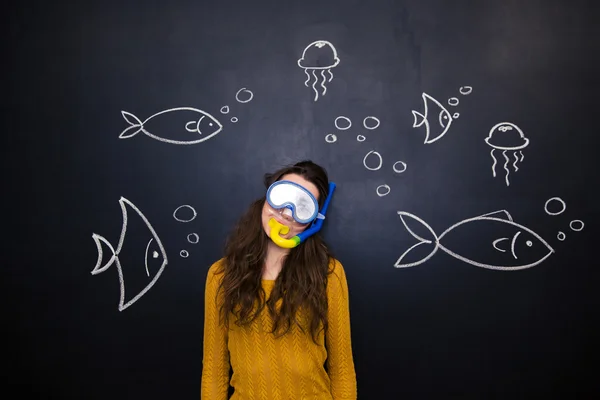 Pretty woman in diving mask over chalkboard with underwater world — 스톡 사진