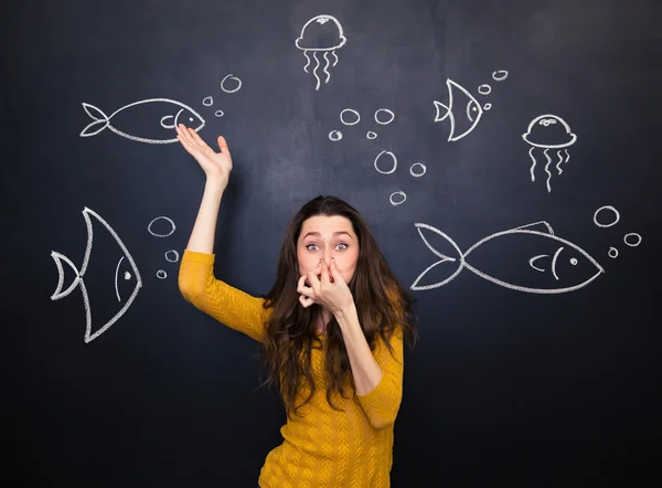 Funny cute woman simulating deep diving over blackboard background — Stok fotoğraf