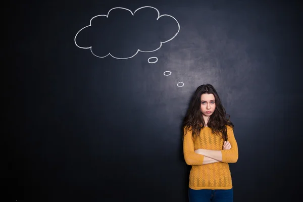 Sad woman standing with arms folded — Stock Photo, Image