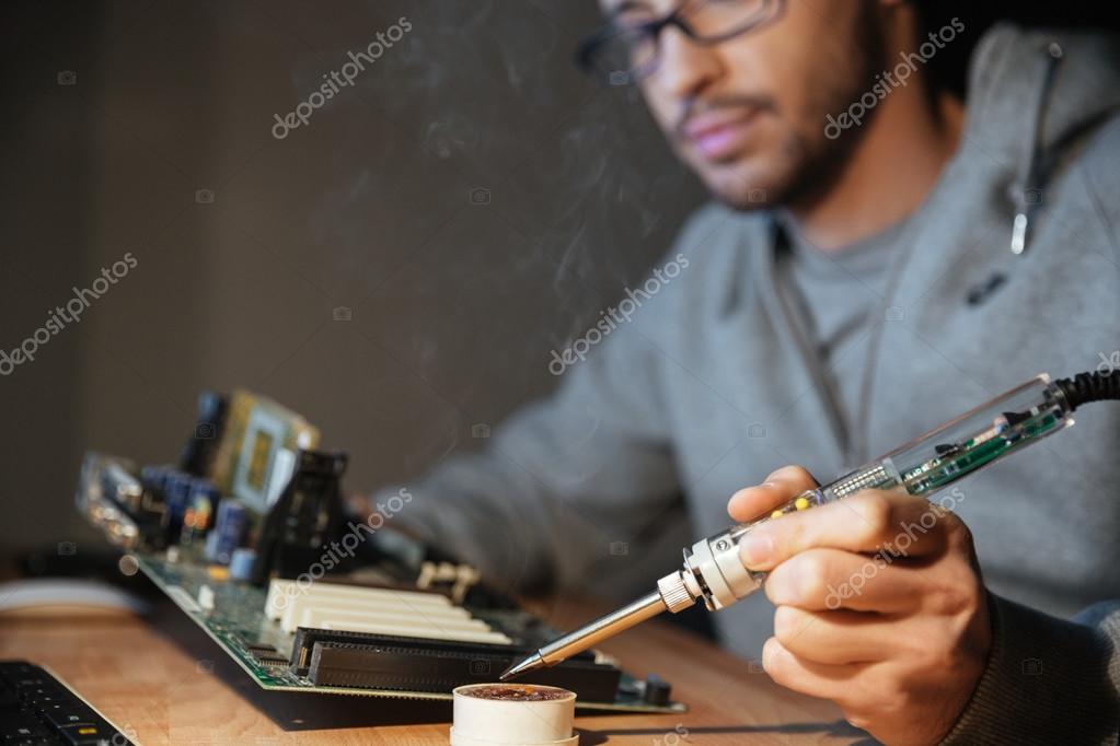 Thoughtful Man Using Soldering Iron For Repairing Motheboard Stock Photo By C Vadymvdrobot Thoughtful Man Using Soldering Iron For Repairing Motheboard Stock Photo By C Vadymvdrobot