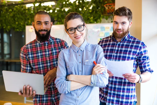 Young business people standing in office — Stock Photo, Image