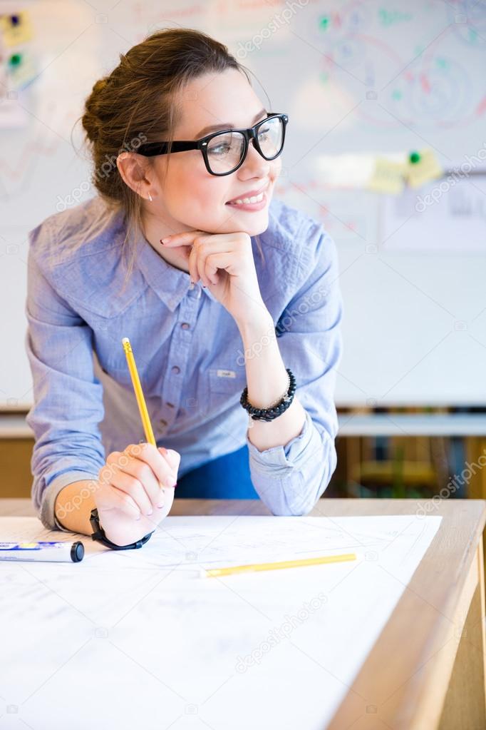 Inspired beautiful business woman working in office