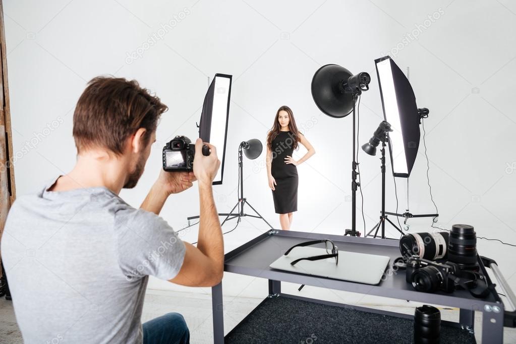Man shooting female model in studio