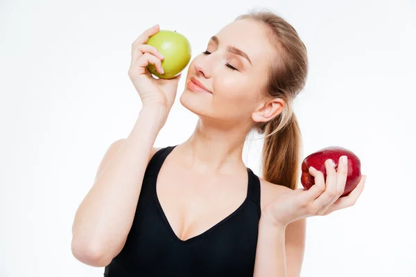 Attractive smiling woman athlete posing with red and green apples — Stock Photo, Image