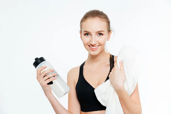 Cheerful woman athlete drinking water anf holding white towel — Stock Photo, Image