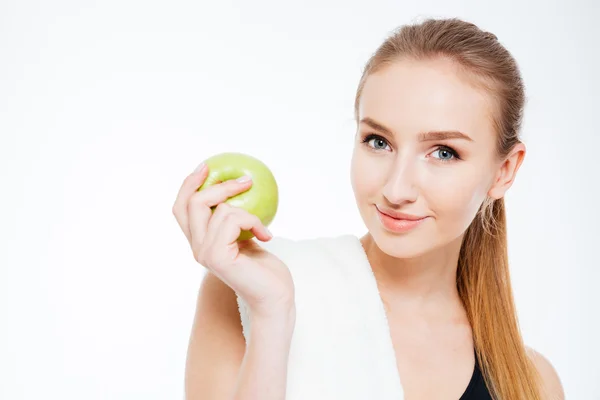 Beautiful young sportswoman holding apple — Stock Photo, Image