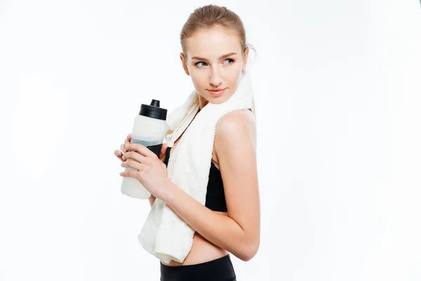 Attractive woman athlete holding bottle of water and white towel — Stock Photo, Image