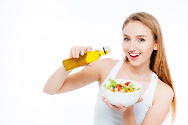 Frau schüttete Öl in Salat — Stockfoto