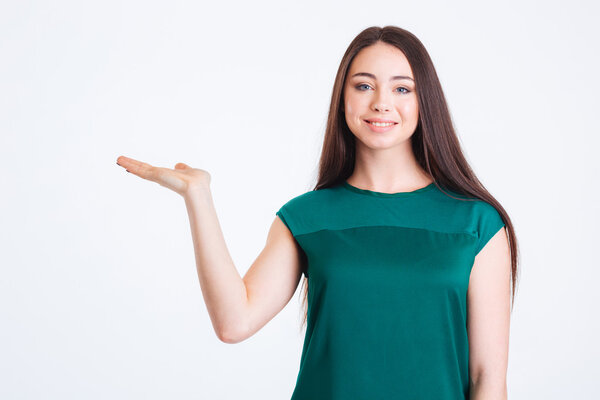 Cheerful pretty young woman holding copyspace on palm