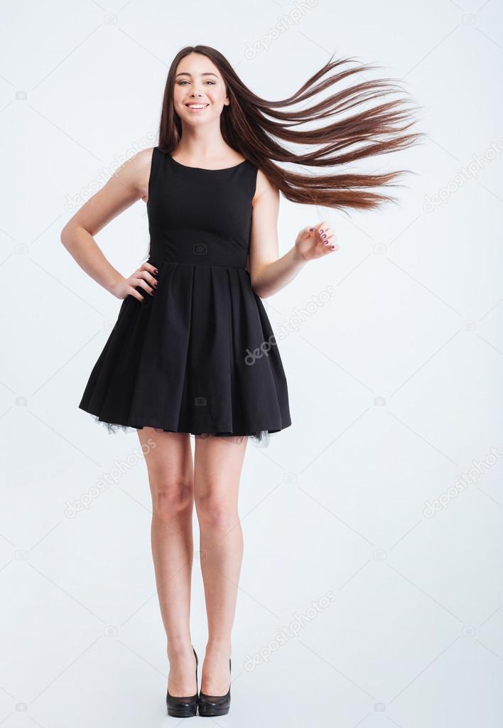 Happy attractive woman with beautiful long dark hair in motion 