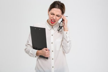 Depressed unhappy young business woman suffering from headache