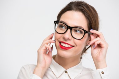 Cheerful pretty business woman in glasses talking on cell phone