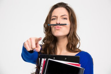 Funny woman simitating moustache with pen and pointing on camera 