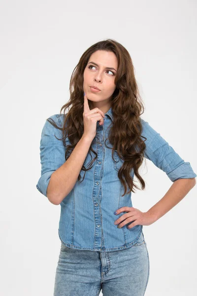 Pensive attractive young woman standing and thinking — Stock Photo, Image