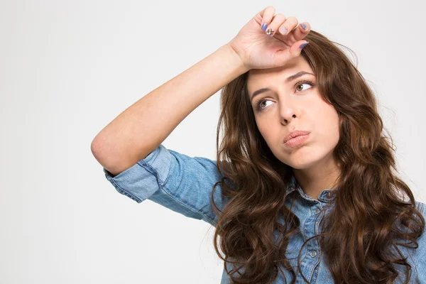 Sad tired young woman with hand on forehead — Stock Photo, Image