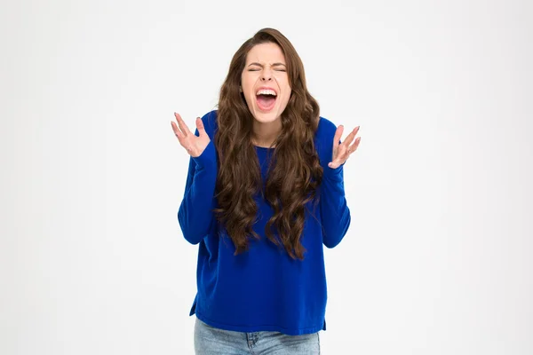 Mad hysterical woman with long curly hair standing and shouting — Stockfoto