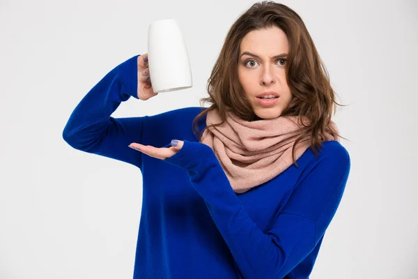 Confused lovely young woman holding empty inverted mug — Stockfoto