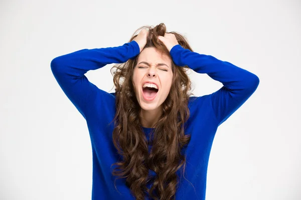 Angry crazy young woman with long curly hair screaming — 图库照片