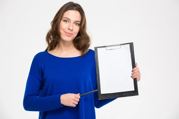 Smiling confident woman holding clipboard and pointing on it — Stockfoto