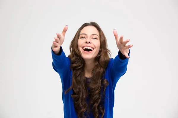 Cheerful excited young woman reaching hands to camera — Stock Photo, Image