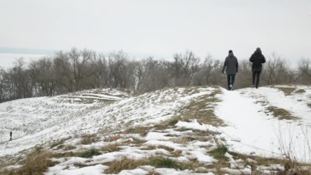 Two Guys Walking Snow Covered Dirt Road Hills — Stock Video