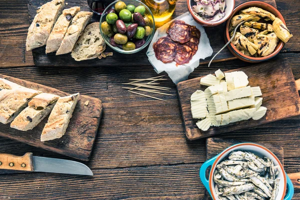 Tapas on kitchen table, from overhead, copy space — Stock Photo, Image