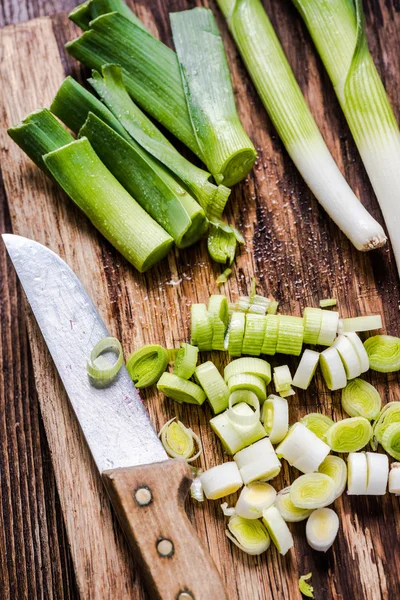 Fresh leek on wooden choping board — Stock Photo, Image