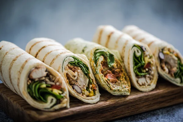 Mexican fajita wraps on serving board, copy space