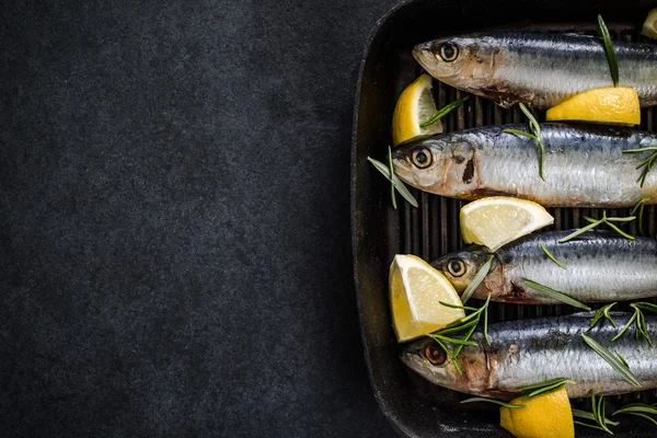 Whole fish sardin on frying pan — Stock Photo, Image