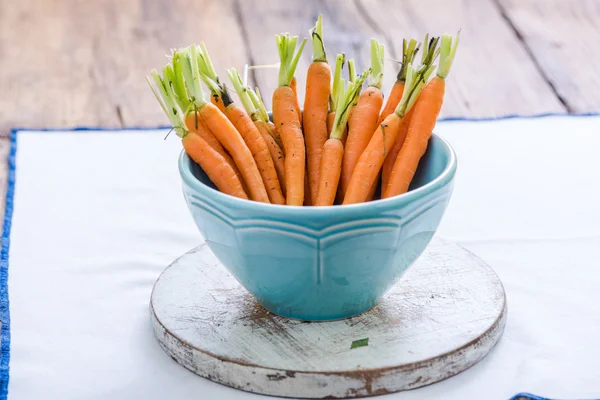 Baby carrots in pastel bowl — Stock Photo, Image