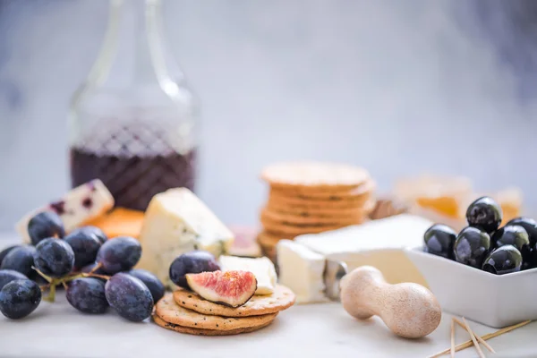 Cheese board with grapes,wine,fig and olives — Stock Photo, Image