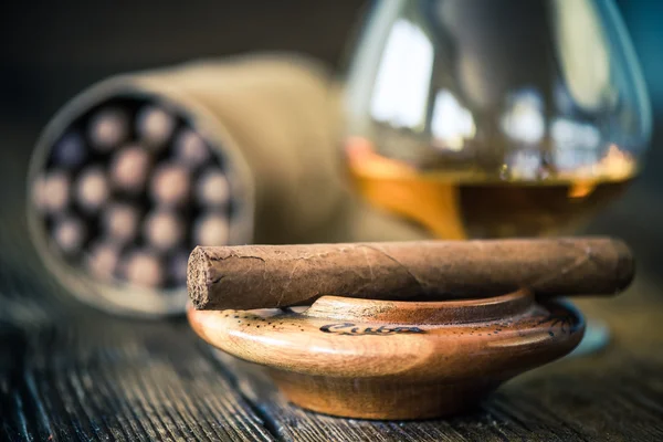 Cuban cigar in ashtray on wooden table — Stock Photo, Image