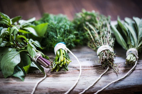 Bunch of herbs on wooden board