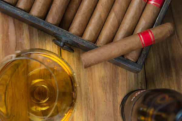 Charutos e rum ou álcool na mesa — Fotografia de Stock