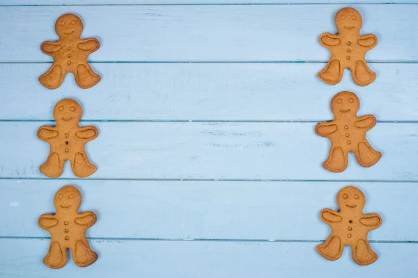 Gingerbread man on wooden background — Stock Photo, Image