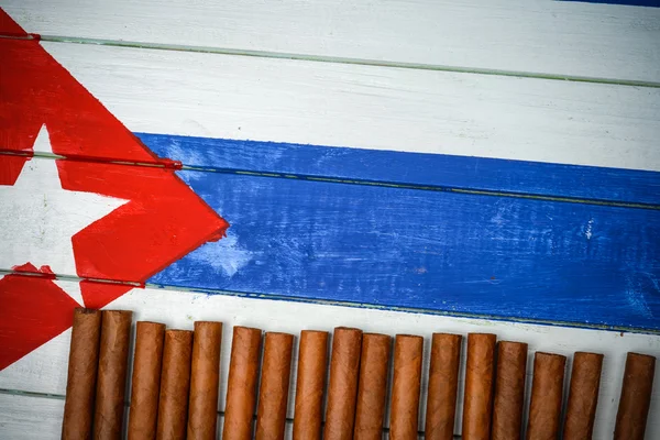 Cigars on painted Cuban national flag — Stock Photo, Image