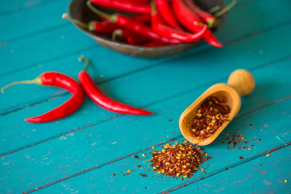 Fresh chilli peppers and scoop with seeds — Stock Photo, Image