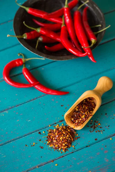Fresh chilli peppers and scoop with seeds — Stock Photo, Image