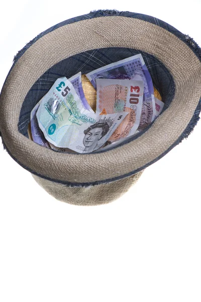 Straw hat filled up with cash — Stock Photo, Image
