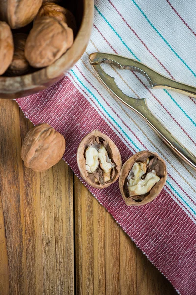 Table top view on nut cracker and open walnut — Stock Photo, Image