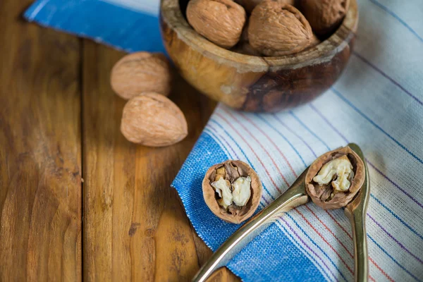 Table top view on nut cracker and open walnut — Stock Photo, Image