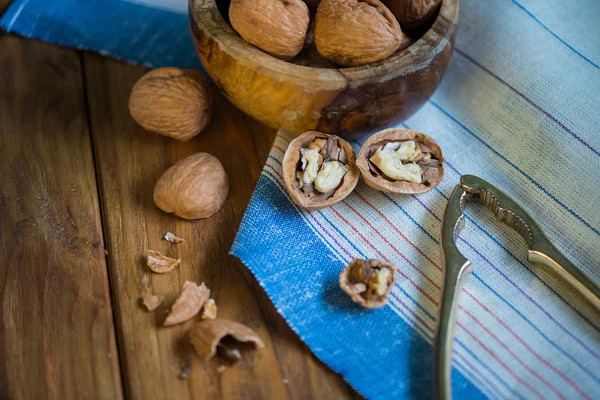 Table top view on nut cracker and open walnut — Stock Photo, Image