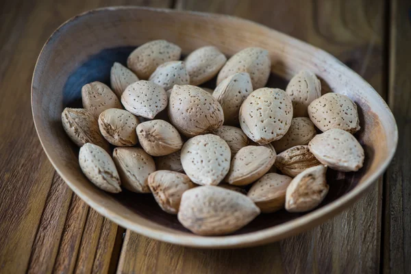 Table top view on almonds in bowl — Stock Photo, Image