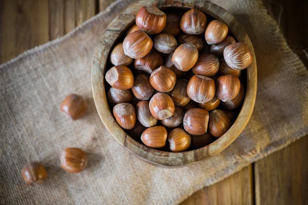 Hazelnuts in vintage bowl on table — Stock Photo, Image